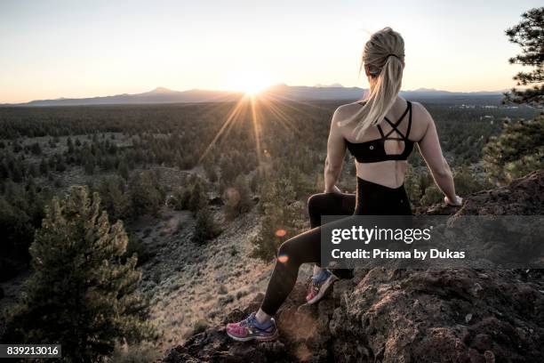 Oregon, Deschutes County, Bend, Woman on Horse Butte watching sunset NR.