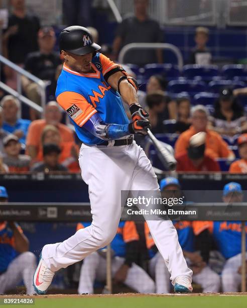 Giancarlo Stanton of the Miami Marlins hits a two run home run in the first inning during a game against the San Diego Padres at Marlins Park on...