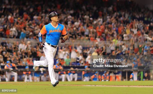 Giancarlo Stanton of the Miami Marlins hits a solo home run in the third inning during a game against the San Diego Padres at Marlins Park on August...