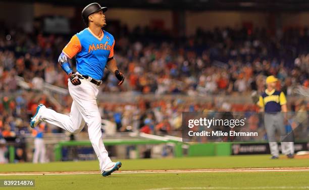 Giancarlo Stanton of the Miami Marlins hits a solo home run in the third inning during a game against the San Diego Padres at Marlins Park on August...