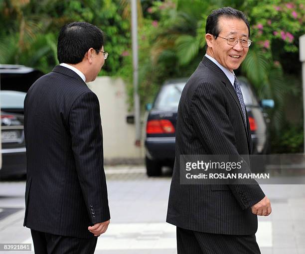 North Korean nuclear negotiator Kim Kye-Gwan smiles after talking to reporters outside the North Korean ambassador's residence after returning from a...