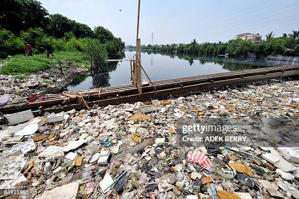 By Stephen Coates. Two men walk next to polluted river in North Jakarta on December 5, 2008. One of the world's most polluted rivers, the Citarum in...