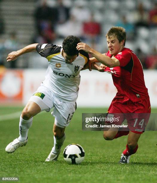 Troy Hearfield of the Phoenix tackled by Scott Jamieson of United during the round 14 A-League match between Adelaide United and the Wellington...