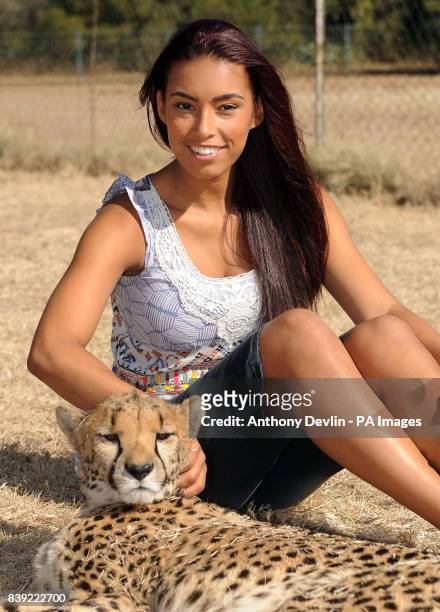 Chantelle Tagoe poses with a two and a half year old cheetah called Bibi during a visit to the Cheetah Experience in Bloemfontein, South Africa.