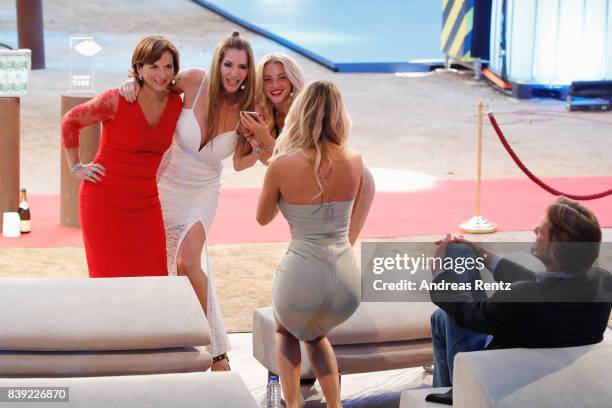 Maria Hering takes a photograph of Claudia Obert, Sarah Kern and Evelyn Burdecki attend the finals of 'Promi Big Brother 2017' at MMC Studio on...