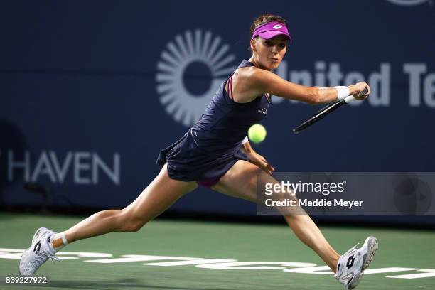 Agnieszka Radwanska of Poland returns a shot to Daria Gavrilova of Australia during Day 7 of the Connecticut Open at Connecticut Tennis Center at...