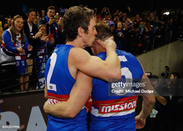 Matthew Boyd is kissed by Robert Murphy of the Bulldogs after losing their retirement match during round 23 AFL match between the Hawthorn Hawks and...