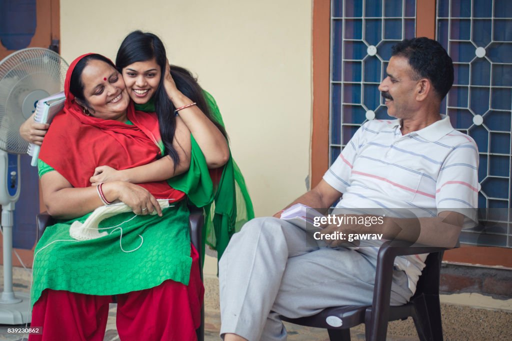 Happy and confident asian college student with her parents.