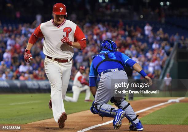 Jerad Eickhoff of the Philadelphia Phillies scores behind Alex Avila of the Chicago Cubs in the second inning at Citizens Bank Park on August 25,...