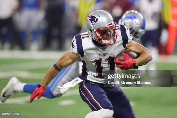 Julian Edelman of the New England Patriots runs for yards after a first quarter catch while playing the Detroit Lions during a preseason game at Ford...