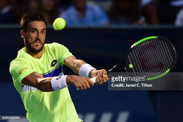 Damir Dzumhur of Bosnia and Herzegovina returns a shot to Kyle Edmund of Great Britain during their semifinals match in the Winston-Salem Open at...