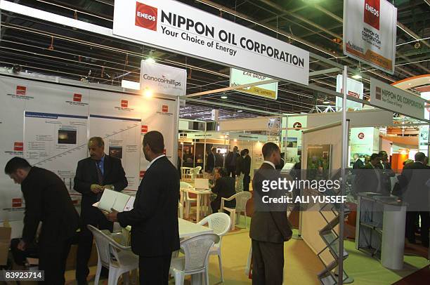 Business men visit a stand at the "First ever Iraq Energy Expo and Conference" held at the convention center of the Iraqi International Airport in...