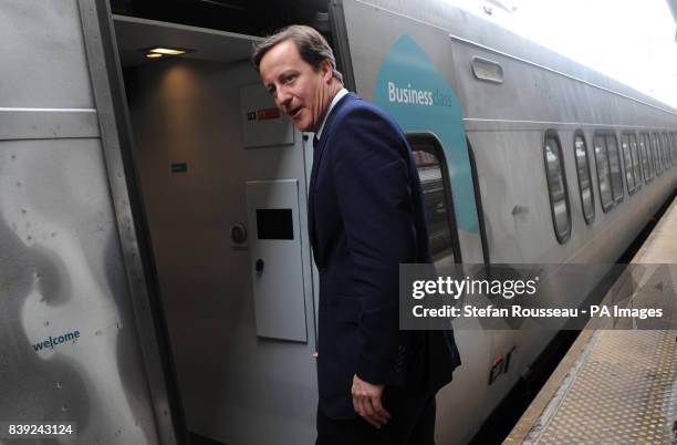 Britain's Prime Minister David Cameron boards the Acela Express from Wasington DC, Washington, to New York's Penn Station, as part of his two day...