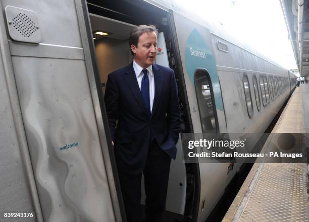 Britain's Prime Minister David Cameron boards the Acela Express from Wasington DC, Washington, to New York's Penn Station, as part of his two day...