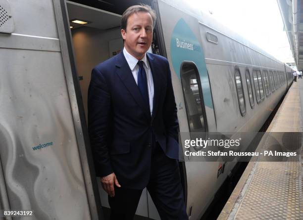 Britain's Prime Minister David Cameron boards the Acela Express from Wasington DC, Washington, to New York's Penn Station, as part of his two day...