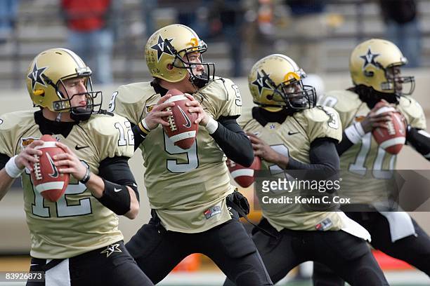 Quarterbacks Jared Funk, Mackenzi Adams, Chris Nickson and Larry Smith of the Vanderbilt Commodores warm up before the game against the Tennessee...