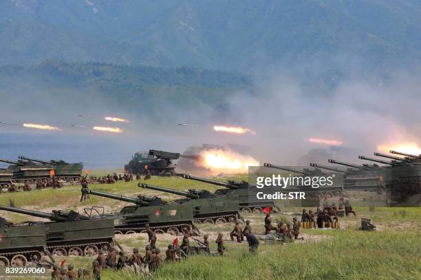 This undated photo released by North Korea's official Korean Central News Agency on August 26, 2017 shows rockets being launched by Korean People's...