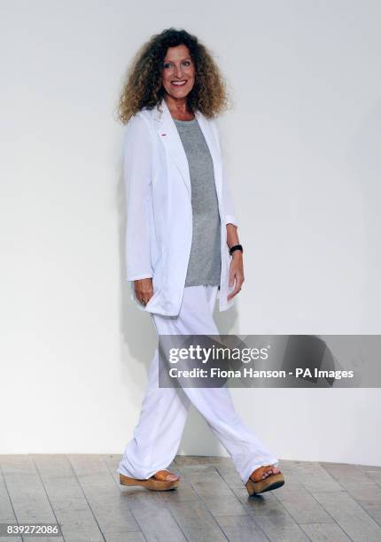 Designer Nicole Farhi accepts applause following her Spring/Summer collection shown in the Floral Hall at the Royal Opera House, London as part of...