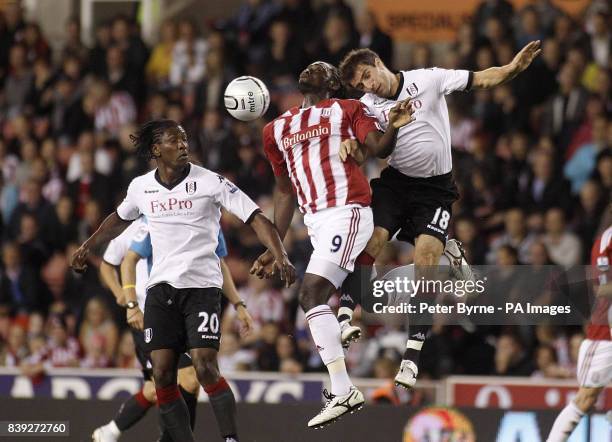 Fulham's Dickson Etuhu and Aaron Hughes in action against Stoke City's Kenwyne Jones