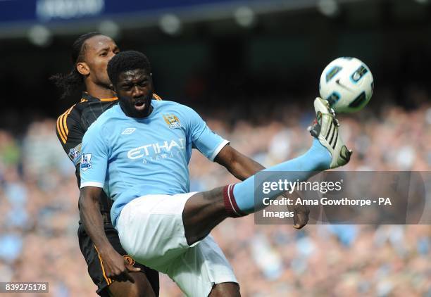Manchester City's Kolo Toure clears whilst under pressure from Chelsea's Didier Drogba
