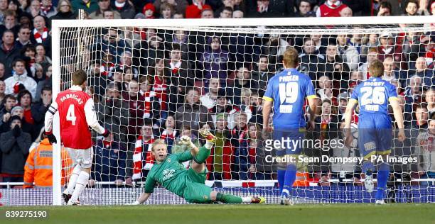 Arsenal's Francesc Fabregas scores his team's equalizing goal past Leeds United's goalkeeper Kasper Schmeichel .