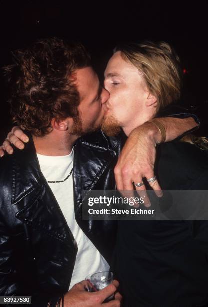 Eric Kretz and Scott Weiland of the Stone Temple Pilots kissing each other at Club USA, 1993.