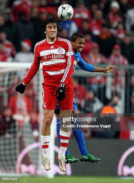 Luca Toni of Bayern challenges Luiz Gustavo of Hoffenheim for the ball during the Bundesliga match between Bayern Muenchen and 1899 Hoffenheim at the...