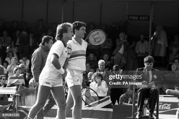 Britain's doubles partners Colin Dowdeswell and John Lloyd leave the court after their victory over Shlomo Glickstein and Shahar Perkiss which gave...