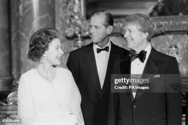 President Jimmy Carter joins Queen Elizabeth II and the Duke of Edinburgh at Buckingham Palace when he and six other world leaders attended dinner in...