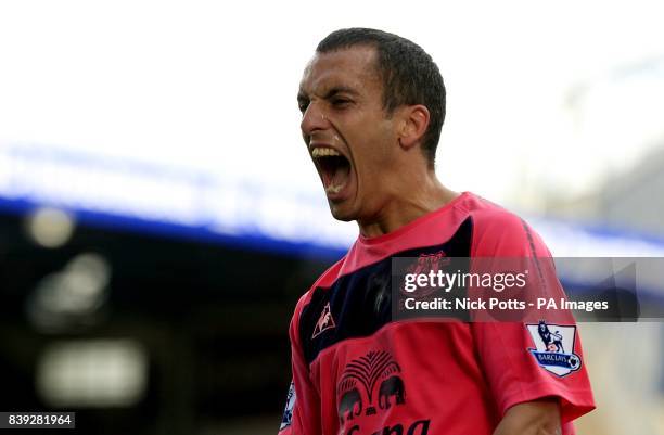 Everton's Leon Osman celebrates after his cross is turned into his own net by Birmingham City's Roger Johnson for the opening goal of the game