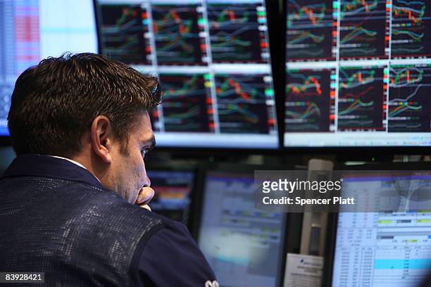 Traders work on the floor of the New York Stock Exchange moments before the closing bell December 5, 2008 in New York City. Despite a new monthly...