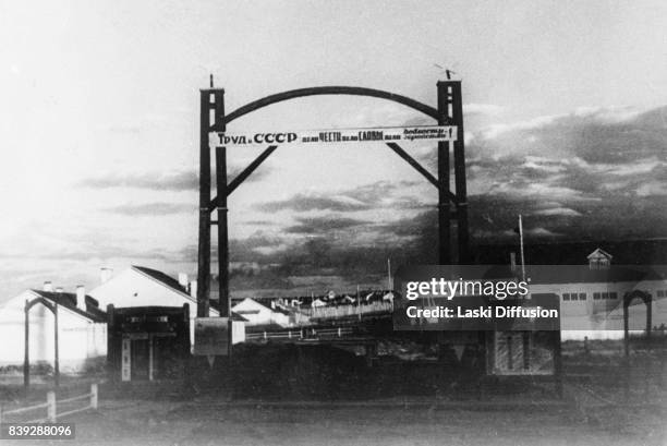 Gate of the Vorkuta coal mine, Vorkuta Gulag , one of the major Soviet labor camps, Russia, Komi Republic, 1945. The slogan above the entrance reads:...