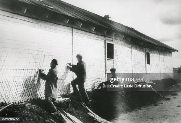 Prisoners building a shack in Vorkuta Gulag , one of the major Soviet labor camps, Russia, Komi Republic, 1945.