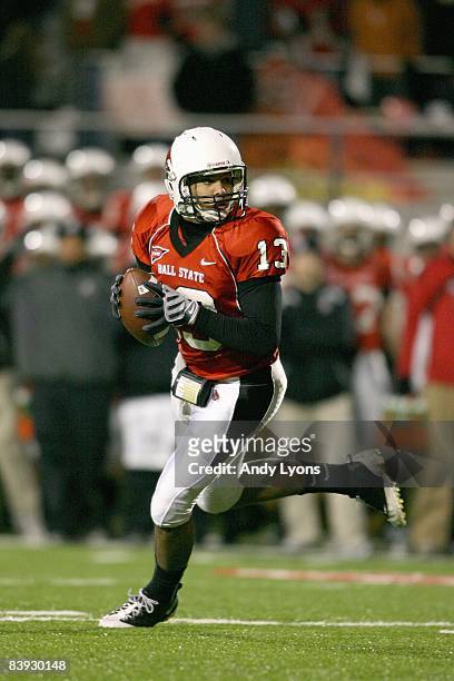 Quarterback Nate Davis of the Ball State Cardinals runs as he looks to pass the ball during the MAC game against the Western Michigan Broncos at...