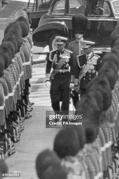 King Bhumibol Aduladej of Thailand inspects a guard of honour of the 3rd Battalion Grenadier Guards with the Duke of Edinburgh, at Victoria Station...