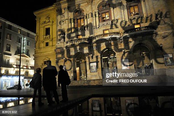 People watch a light show on December 5, 2008 in Lyon, central eastern France, as part of the 10th edition of the "Fete des lumieres" , the secular...