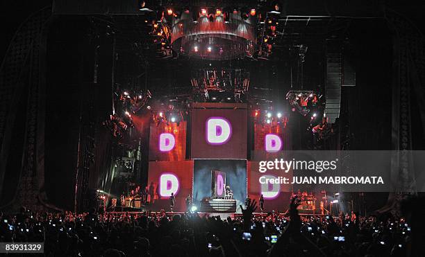 Hundreds of cell phones and digital cameras rise at Monumental stadium in Buenos Aires on December 5, 2008 waiting to catch an image of US singer...