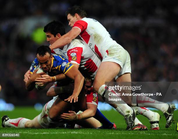 Leeds Rhinos' Jamie Jones-Buchanan is tackled by St Helens' James Graham , Chris Flannery and Matt Gidley during the Super League Grand Final match...