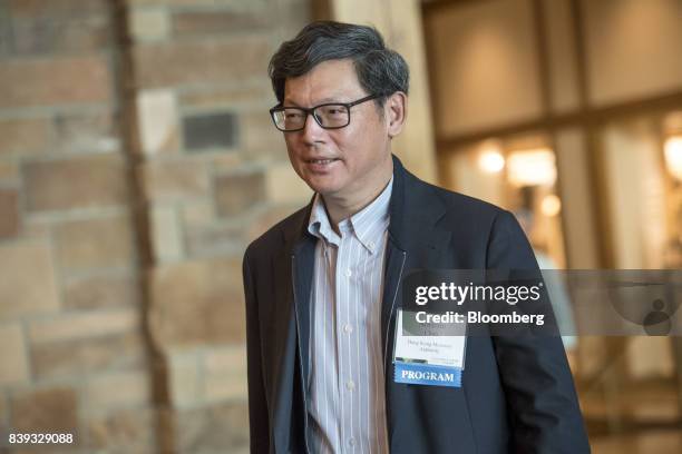 Norman Chan, chief executive of the Hong Kong Monetary Authority, arrives for a dinner during the Jackson Hole economic symposium, sponsored by the...