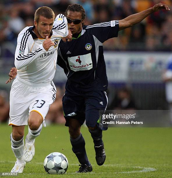 David Beckham of the LA Galaxy gets past Edgar Davids of the Oceania All Stars during the match between the Oceania All Stars and the LA Galaxy held...