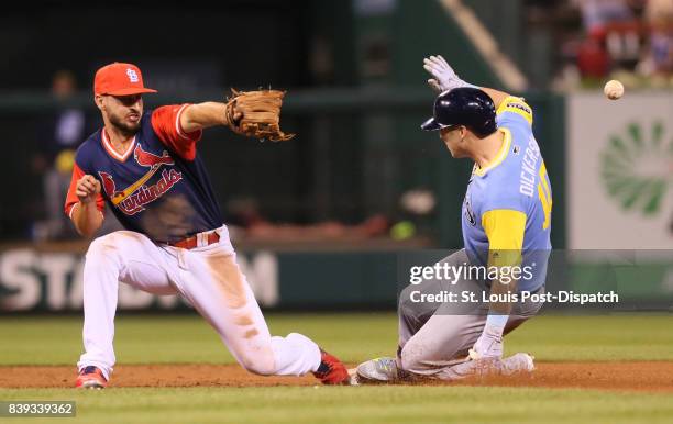 Tampa Bay Rays' Corey Dickerson is hit in the back by a throw from St. Louis Cardinals right fielder Stephen Piscotty as he slides into second with a...