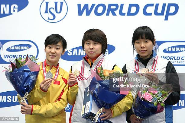 Silver medalist Liu Qiuhong of China, gold medalist Wang Meng of China and bronze medalist Yang Shin-young of South Korea pose for photographers on...