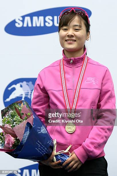 Gold medalist Kim Min-jung of South Korea celebrates on the podium at the award ceremony after the Ladies 1500m final during the Samsung ISU World...
