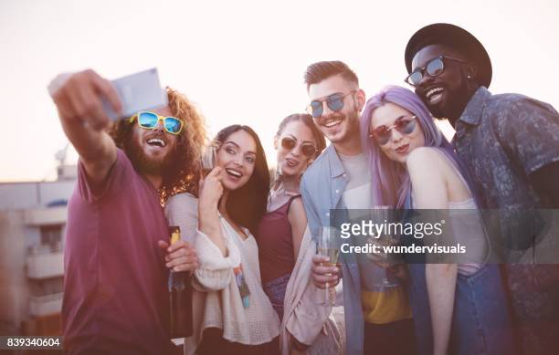 multi-ethnic friends celebrating and taking a selfie at summer party - champagne rooftop stock pictures, royalty-free photos & images