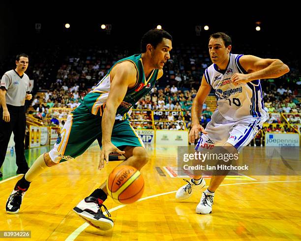 Michael Cedar of the Crocs drives past Jason Smith of the Spirit during the round 12 NBL match between the Townsville Crocodiles and the Sydney...