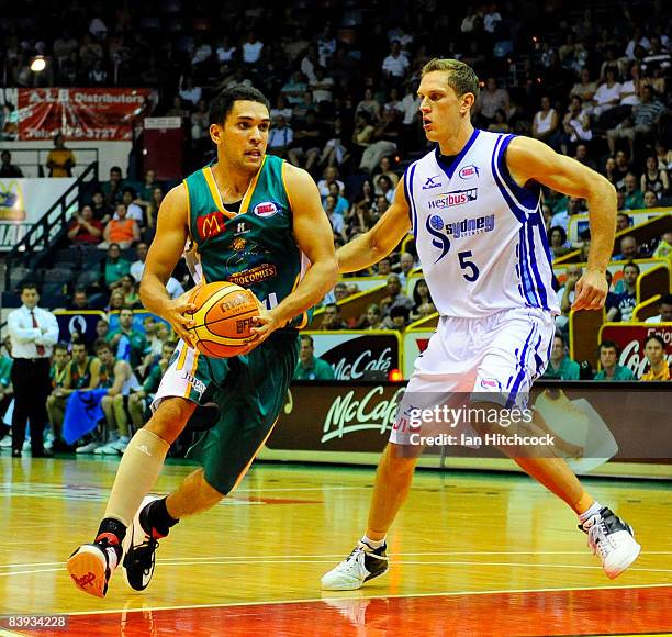 Michael Cedar of the Crocslooks to get past Graeme Dann of the Spirirt during the round 12 NBL match between the Townsville Crocodiles and the Sydney...