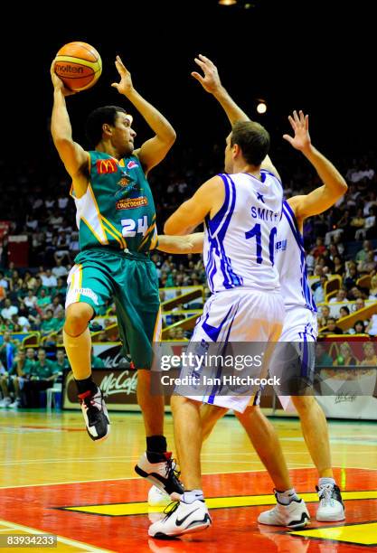 Michael Cedar of the Crocs looks to get a pass away despite the Spirit defence during the round 12 NBL match between the Townsville Crocodiles and...