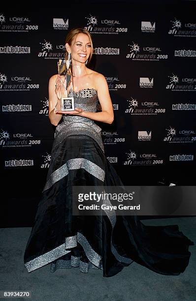Actress Kat Stewart poses with the AFI Award for Best Lead Actress in a Television Drama for "Underbelly" backstage in the Awards Room at the L'Oreal...