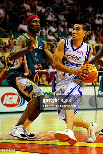 Luke Martin of the Spirit drives to the basket despite the defence of rosell Ellis of the Crocs during the round 12 NBL match between the Townsville...