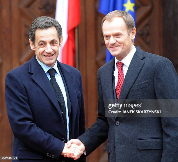 French President Nicolas Sarkozy shakes hands with Polish Prime Minister Donald Tusk prior a meeting in Gdansk on December 6, 2008. French President...